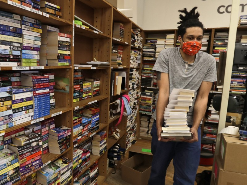 Dan Loftus carries books at Half Price Books in Mayfield Heights, Ohio on May 11, 2020