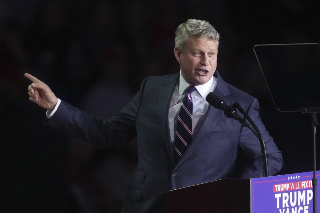 U.S. Rep. Bill Huizenga speaks into a microphone.
