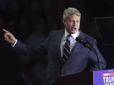 U.S. Rep. Bill Huizenga speaks into a microphone.