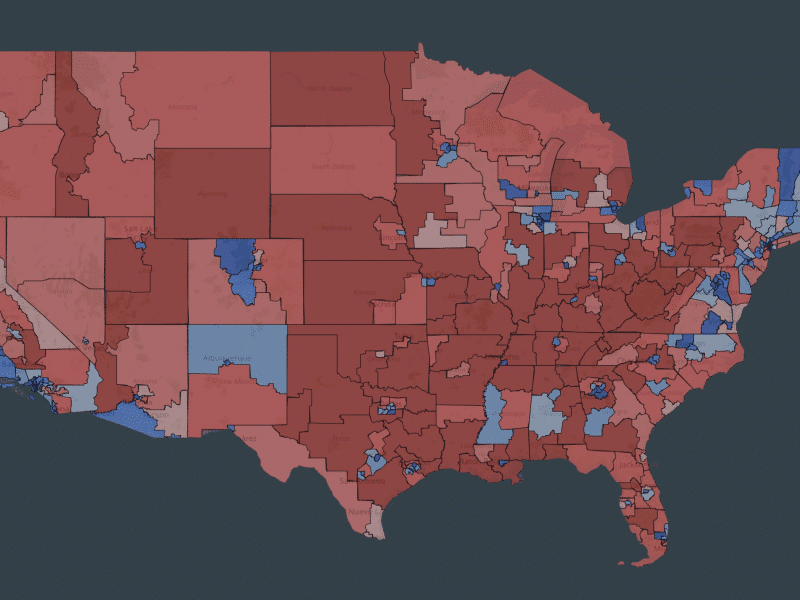 A political map of the United States shows the country divided into congressional districts, colored in varying shades of red and blue to indicate partisan lean. The majority of the map's geographic area, particularly across the Great Plains, South, and Mountain West, is dominated by shades of red. Blue areas are concentrated in urban centers, parts of the West Coast, the Northeast, and scattered districts across the South.