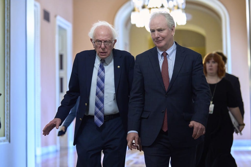 U.S. Senators Bernie Sanders and Chris Van Hollen walk together in the U.S. Capitol.