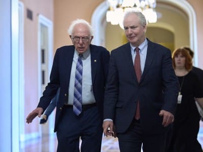 U.S. Senators Bernie Sanders and Chris Van Hollen walk together in the U.S. Capitol.