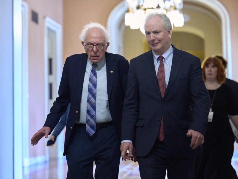 U.S. Senators Bernie Sanders and Chris Van Hollen walk together in the U.S. Capitol.