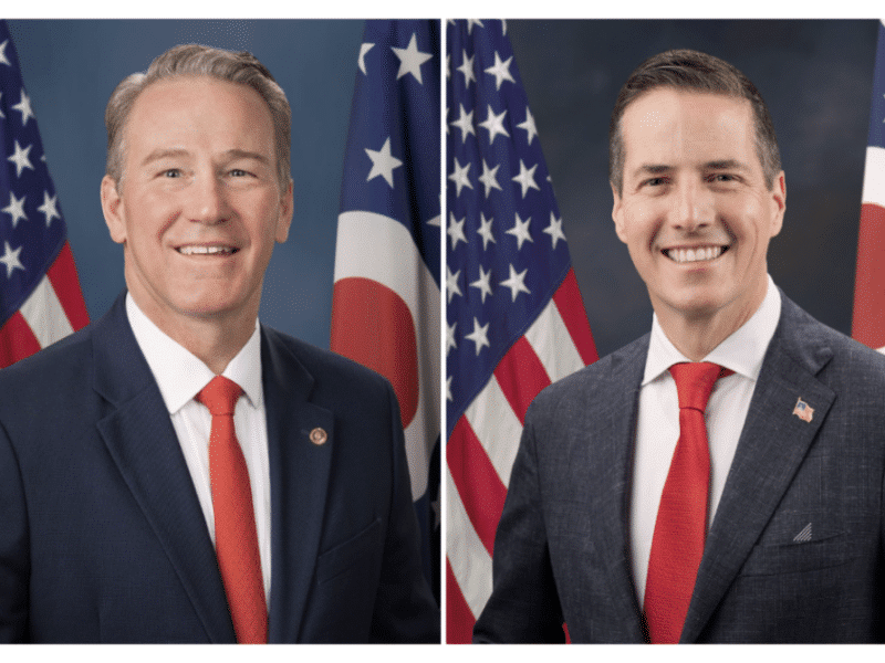 Side-by-side official portraits of Jon Husted and Bernie Moreno, both smiling in front of U.S. and Ohio flags.
