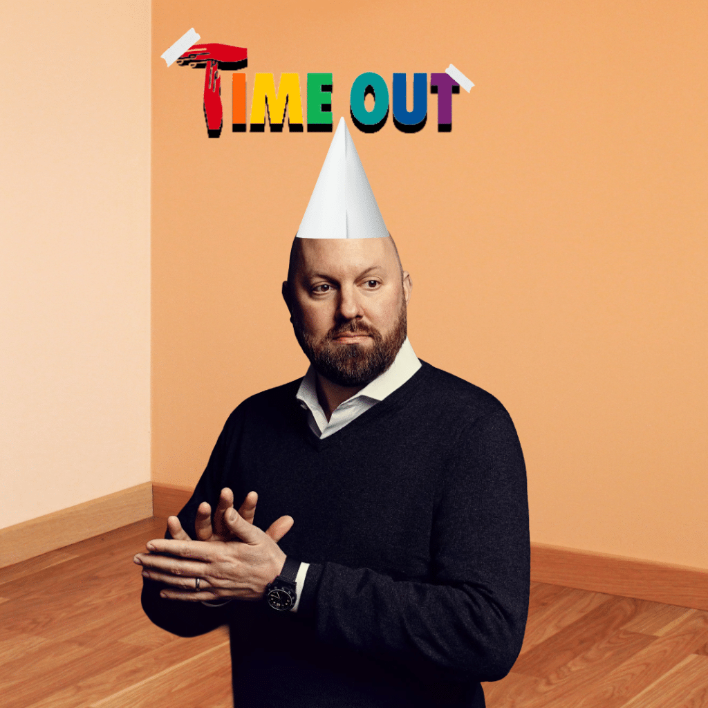 A photoshopped image of Marc Andreessen standing in a room corner, wearing a white dunce cap. Colorful text taped to the wall above him reads "TIME OUT".