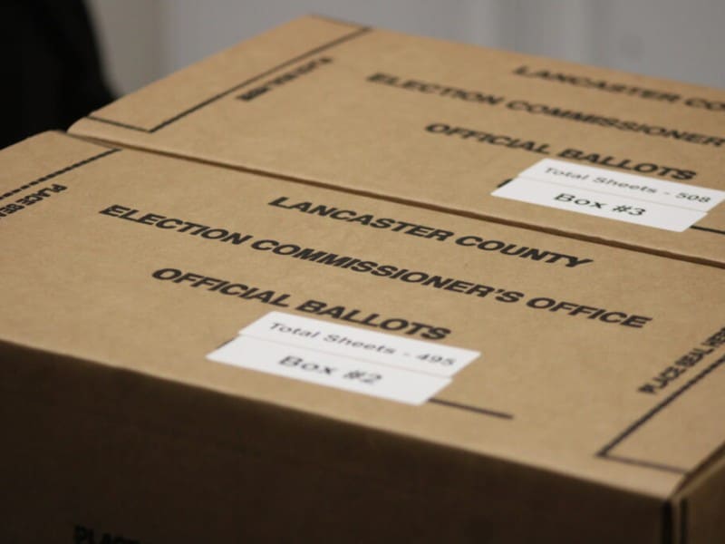 Two closed cardboard boxes labeled "Lancaster County Election Commissioner's Office - Official Ballots."