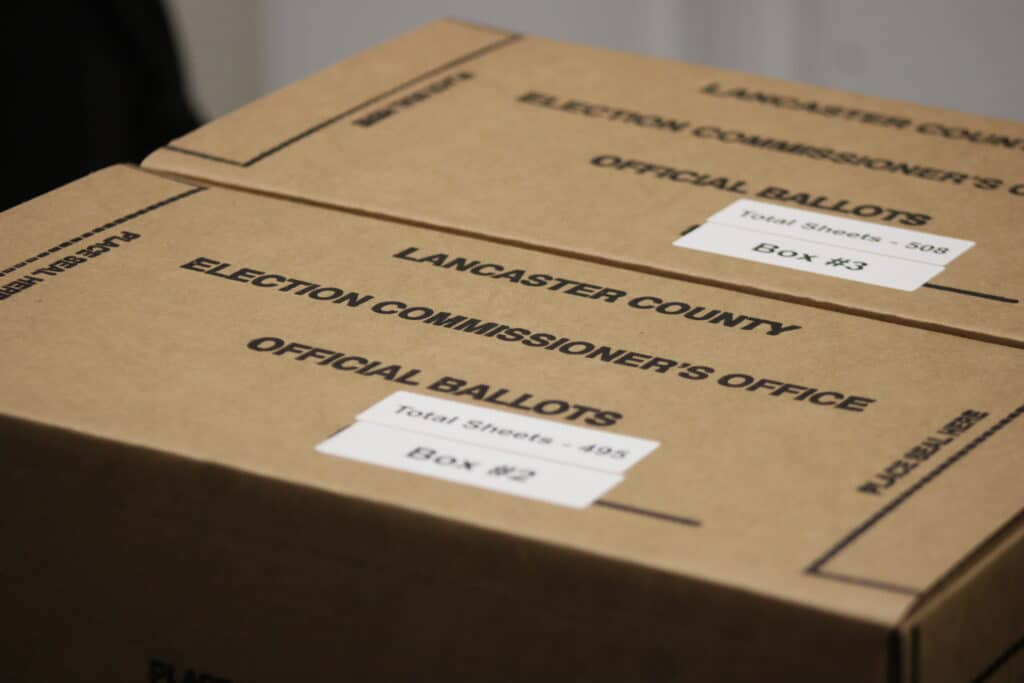 Two closed cardboard boxes labeled "Lancaster County Election Commissioner's Office - Official Ballots."