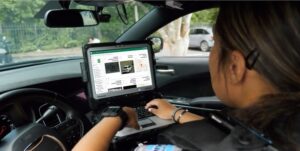 A police officer uses the Flock Safety license plate reader system.