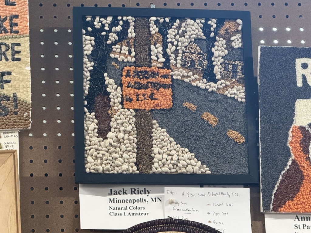 Seed art of a snowy neighborhood street with an orange sign, titled "A Person Was Abducted Here by I.C.E."