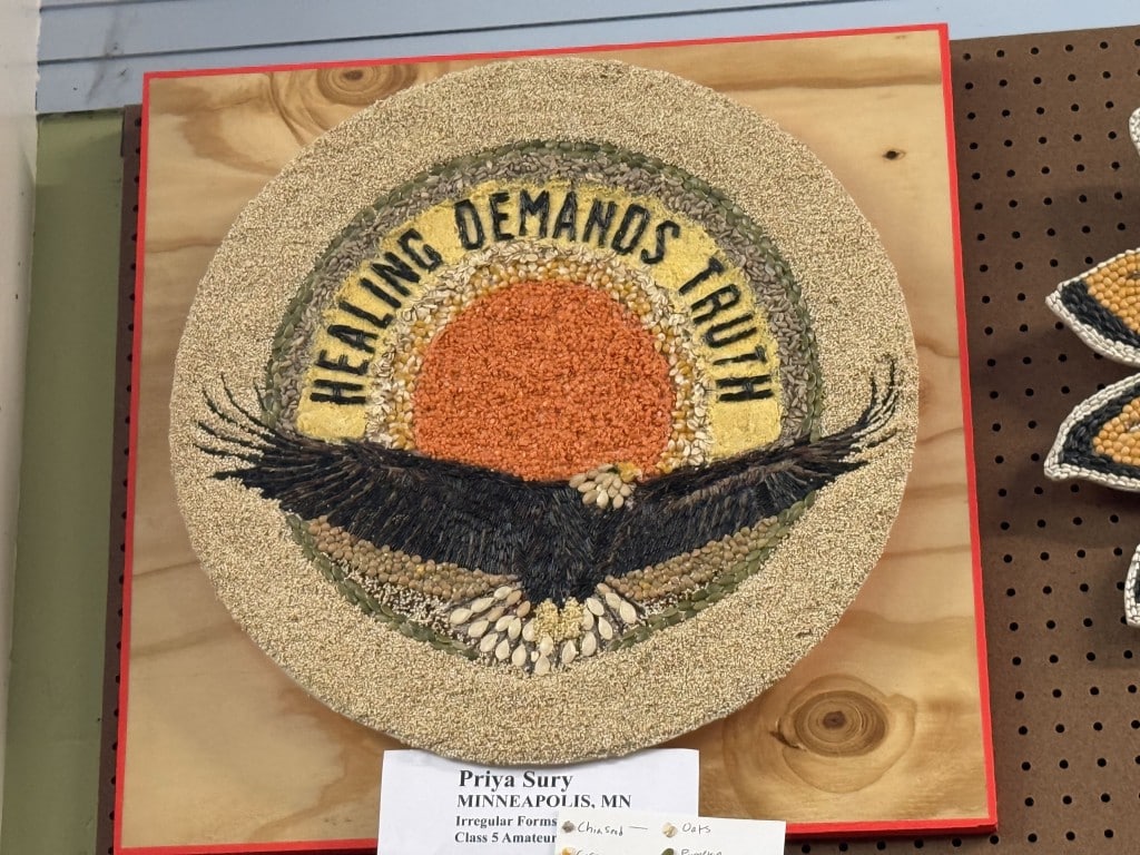 Circular seed art featuring a soaring eagle and a rising sun beneath the text "HEALING DEMANDS TRUTH."
