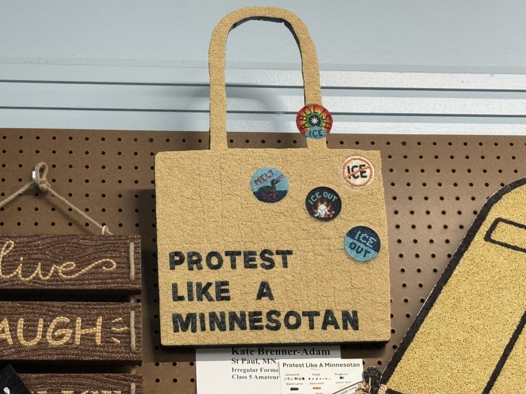 Seed art shaped like a tote bag decorated with anti-ICE pins and the text "PROTEST LIKE A MINNESOTAN."