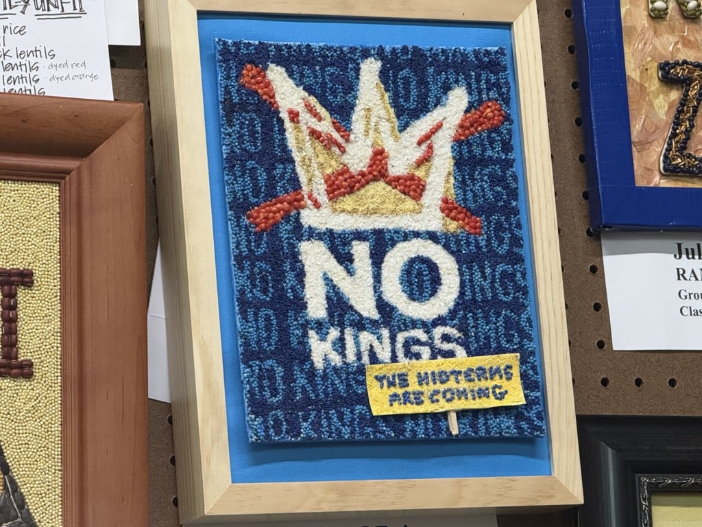 Seed art of a crossed-out crown above text reading "NO KINGS" and "THE MIDTERMS ARE COMING."