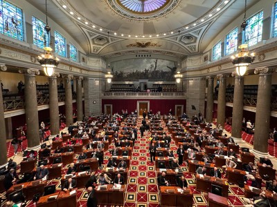 Lawmakers fill desks across the Missouri House chamber beneath a high skylight dome and stained glass windows.