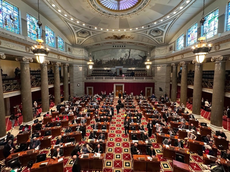 Lawmakers fill desks across the Missouri House chamber beneath a high skylight dome and stained glass windows.
