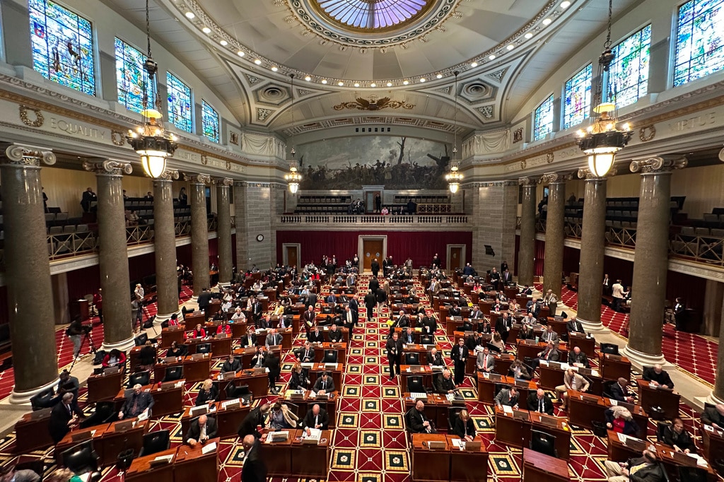 Lawmakers fill desks across the Missouri House chamber beneath a high skylight dome and stained glass windows.
