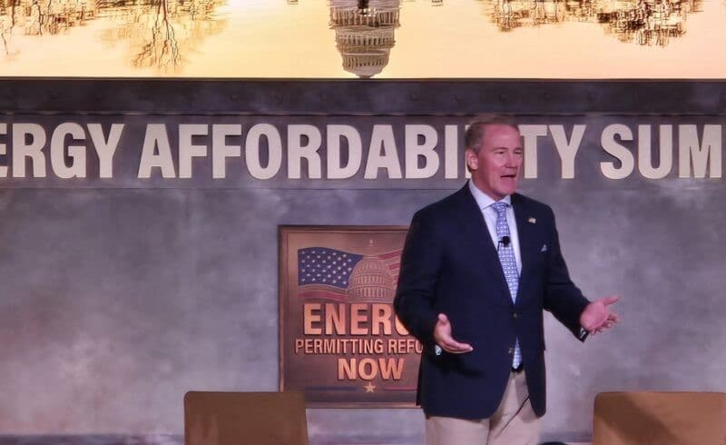 Jon Husted speaks on stage in front of a banner reading "Energy Affordability Summit."