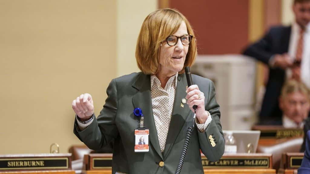 Rep. Bernie Perryman speaks into a microphone on the Minnesota House floor