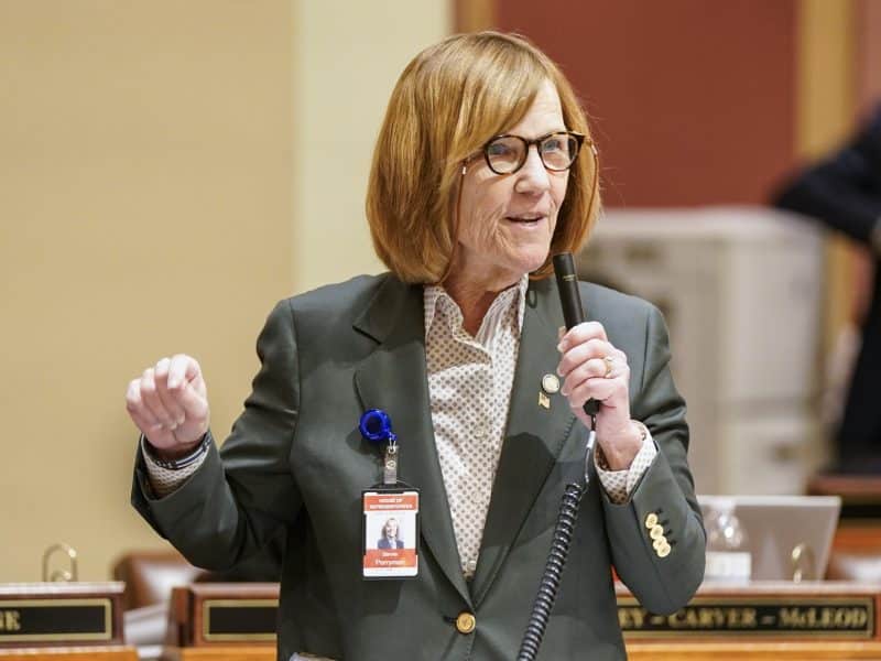 Rep. Bernie Perryman speaks into a microphone on the Minnesota House floor